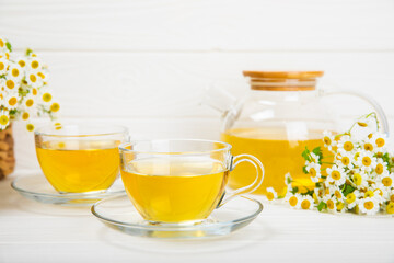 Herbal tea with fresh chamomile flowers on textured background. Calming and relaxing drink. Immunity.Cup of hot chamomile tea. Tea drinking concept. Tea ceremony. Place for text, copy space.
