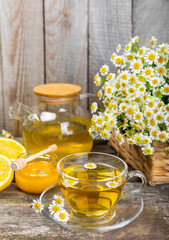 Herbal tea with fresh chamomile flowers on textured background. Calming and relaxing drink. Immunity.Cup of hot chamomile tea. Tea drinking concept. Tea ceremony. Place for text, copy space.