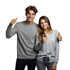 Happy young couple hugging thumbs up gray wall