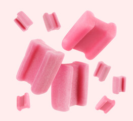 Many bubble gum pillows falling on light background