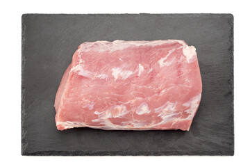 Top view of a piece of fresh pork meat on a mica board over a white background.
