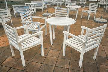 Empty outdoor cafe. Round wooden tables and chairs outside