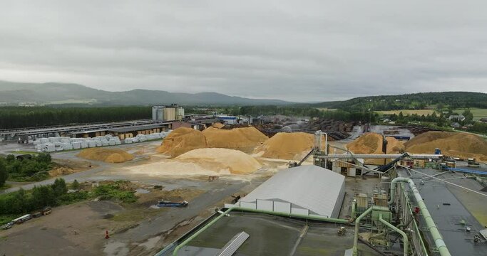 Commercial saw mill and dust in a yard. Drone flyover. Norwegian forestry business, lumber produce.