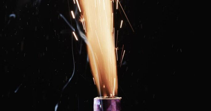 Video of torch with yellow flame and sparks and copy space on black background