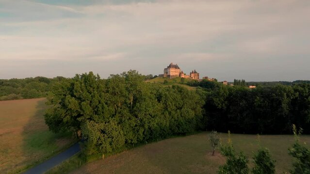 Castle Of Biron Emerging From Behind A Tree. Forward, Aerial Camera Move.