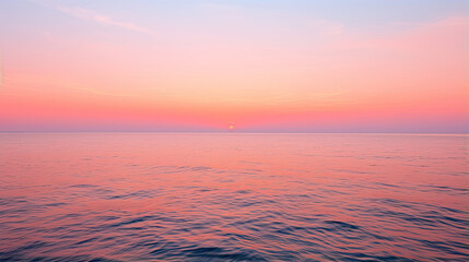 Naklejka na ściany i meble Sunrise over a calm ocean horizon with hues of orange and pink