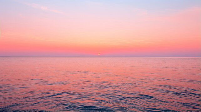 Sunrise over a calm ocean horizon with hues of orange and pink