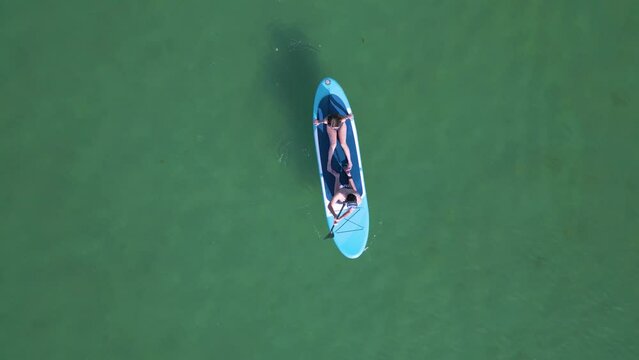 Couple Canoeing On The Calm Ocean Near Aldan, Galicia Spain. Aerial Topdown