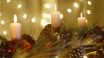 Camera focus slowly transitions backwards, revealing a cozy Christmas home interior with decorations and candles.