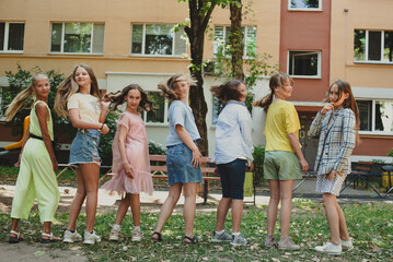 Seven little girls are messing around at their friend's birthday party
