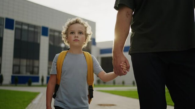 Little Boy Goes To School At First Time, Portrait Of Cute Caucasian Schoolboy Holding Dad Hand