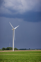 wind turbine in the cornfield before a storm
