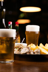 Pub happy hour with 2 pints of beer and fingerfood with chips and sausage