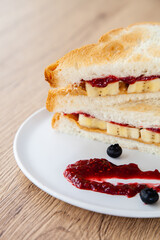 peanut butter and jelly sandwich with banana and fresh blueberry