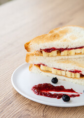 peanut butter and jelly sandwich with banana and fresh blueberry