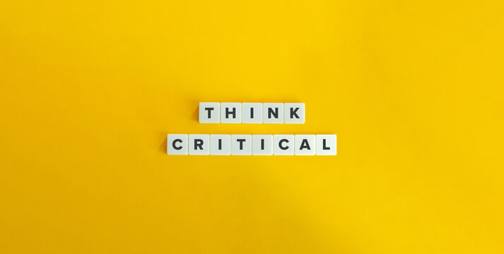 Think Critical Text on Letter Tiles on Yellow Background. Minimal Aesthetic.