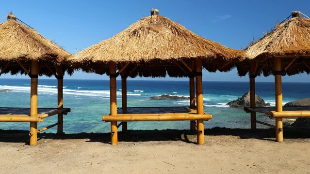 beach hut looking over the ocean on sandy beach in Indonesia. beach view in Lombok, Indonesia