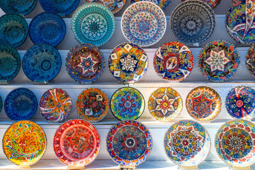 Souvenir shop with the sale of colorful plates in the city of Gjirokaster or Gjirokastra. Albanian - obrazy, fototapety, plakaty