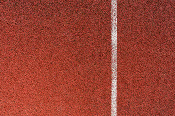 Running track surface with lanes and lines on a track and field athletics stadium. Sport running, jogging or walking runway.