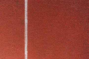 Running track surface with lanes and lines on a track and field athletics stadium. Sport running, jogging or walking runway.