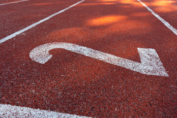 Running track lane number, starting line sign. Surface with lines and numbered lanes on a track and...