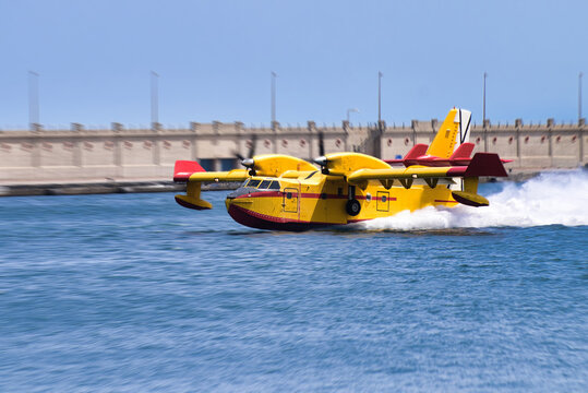 Seaplane in sea water with splashes behind