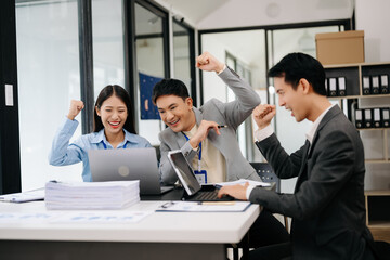 Group of Young Asian business team creative businesspeople coworker, teamwork celebrating achievement and in planning design in creative in office.