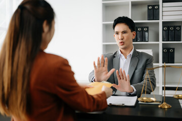 Lawyer refusing bribe money in the envelop from business man at the lawyer modern office..