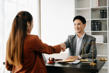 Man lawyer hand and women client shaking hand collaborate on working agreements with contract...