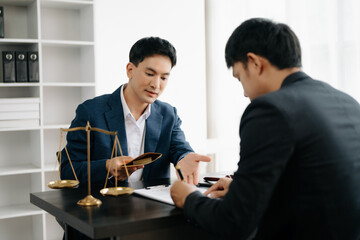 Asian business team and lawyers discussing contract papers sitting at the table. Concepts of law, advice, legal services. at office