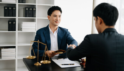 Asian business team and lawyers discussing contract papers sitting at the table. Concepts of law, advice, legal services. at office