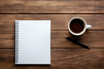 Notepad on the table next to the coffee, top view