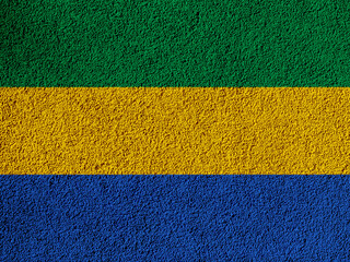 Flag of Republic of Gabon on a textured background. Concept collage.
