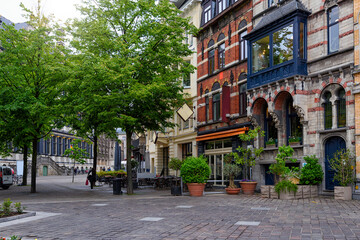 Old narrow street with tables of cafe in Ghent (Gent), Belgium. Architecture and landmark of Ghent....