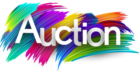 Auction paper word sign with colorful spectrum paint brush strokes over white.