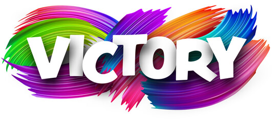 Victory paper word sign with colorful spectrum paint brush strokes over white.