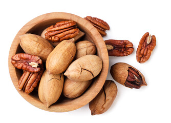 Pecan nuts in shell and peeled in a wooden plate on a white background. Top view