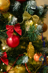 Red and golden baubles on christmas tree for background. New Year concept.
