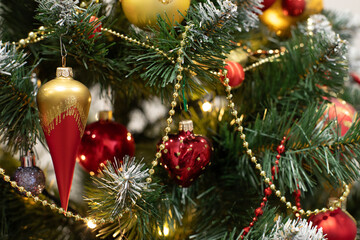 Red baubles and decorations on christmas tree for background. New Year concept.