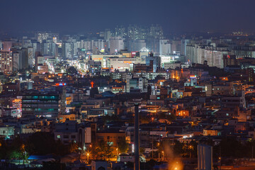 Fototapeta na wymiar IKSAN, SOUTH KOREA: elevated night view of Iksan city center from the top of Baesan Hill