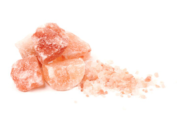 Chipped Himalayan salt stone, crystals and crushed blocks of natural pink salt isolated on white background - obrazy, fototapety, plakaty