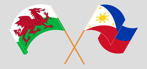 Crossed and waving flags of Wales and the Philippines