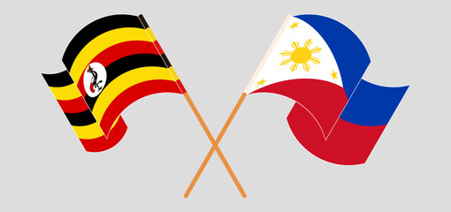 Crossed and waving flags of Uganda and the Philippines
