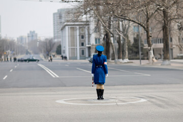 PYONGYANG, NORTH KOREA: traffic lady regulating circulation at a crossroads, since there are no streetlights in Pyongyang, the Traffic Girls are the best way to maintain order on roadways