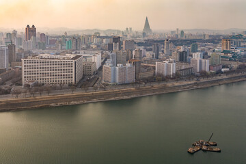 PYONGYANG, NORTH KOREA: general view of  city skyline from Yanggakdo International Hotel, with Taedong River and massive pyramidal silhouette of Ryugyong hotel
