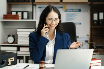 Legal counsel talking mobile phone with legal advice  to the client a signed contract with legal....