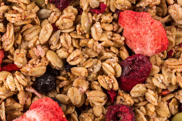 Muesli oat cereals close up background with dry fruits