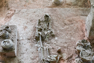 Human and dog skeletons with Dvaravati period items discovered in Si Thep Historical Park,...