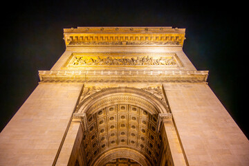 Detailed view of Arc de Triomphe from bottom by night, Paris, France