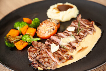 Striploin angus steak with mashed potato and grilled vegetable